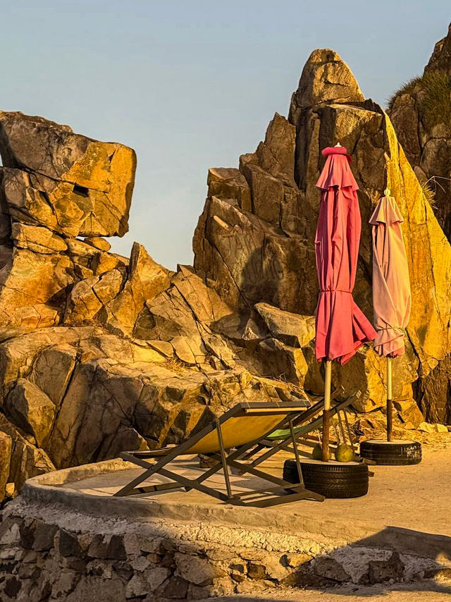 Hidden cave coffee interior with natural rock walls and ocean view Nha Trang