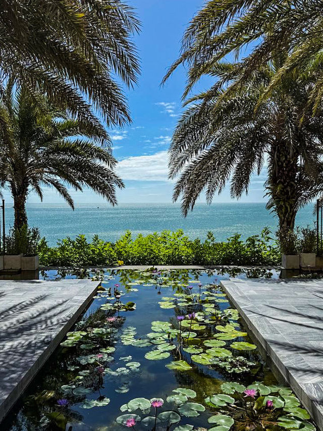 Mediterranean white‑washed walls and palm trees at Mui Ne water castle