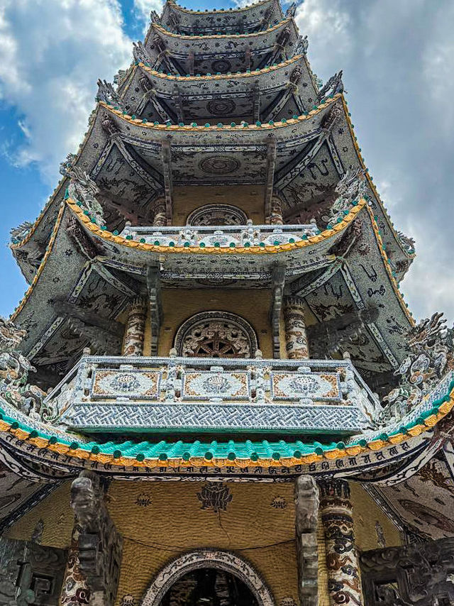 Monks praying inside the main hall of beer bottle dragon pagoda