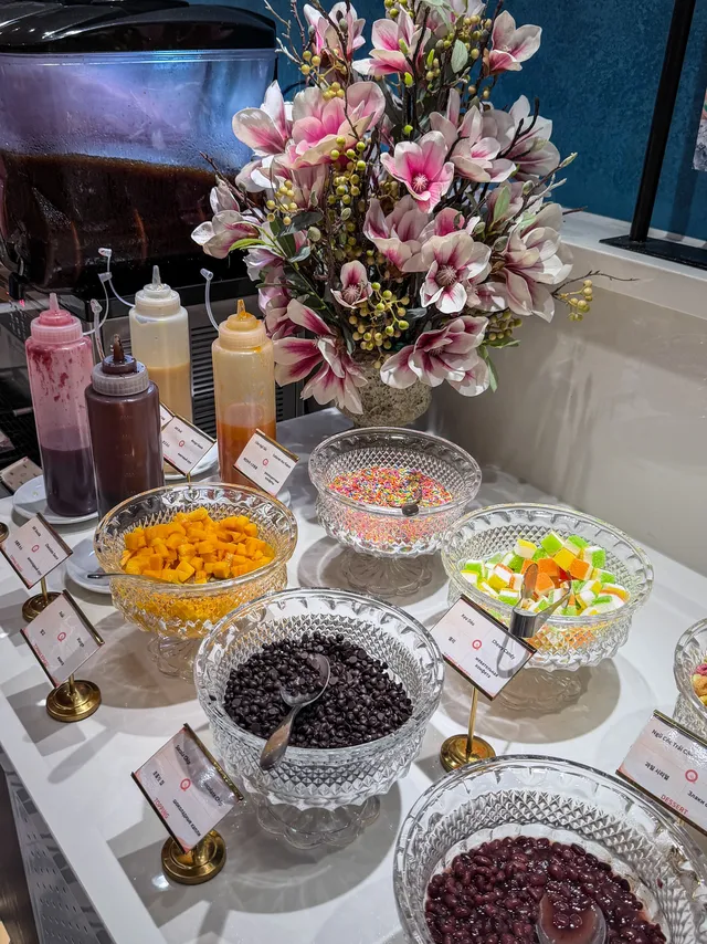 Dessert section with cakes, jelly, and fresh fruit at QooQoo Buffet Nha Trang