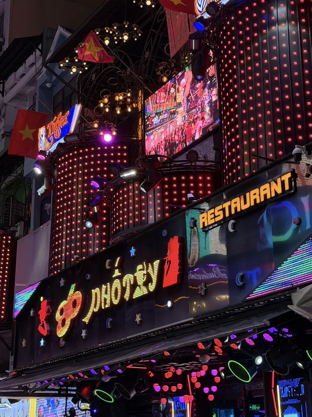 Neon lights and street performers on Bui Vien Walking Street