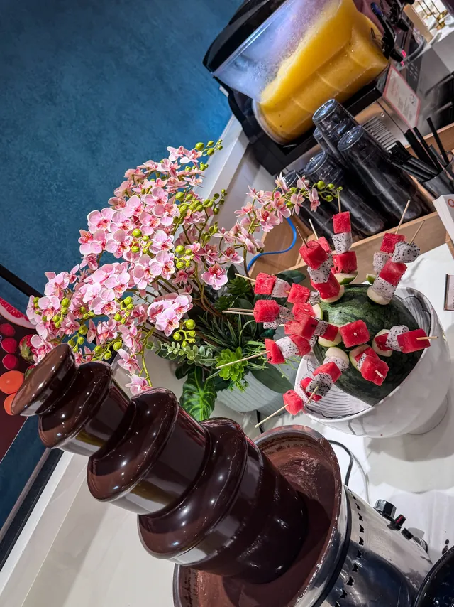 Chocolate fondue fountain with fruits and marshmallows at QooQoo Buffet Nha Trang
