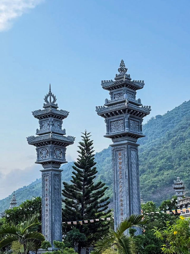 Stone carvings and bonsai garden at peaceful 48m buddha vietnam temple complex