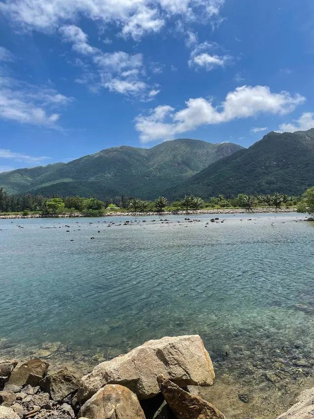 Turquoise water and jungle cliffs at Nhũ Tiên Beach Nha Trang Little Bali