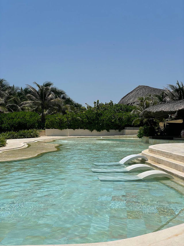 Traditional Vietnamese conical‑hat roofs at vietnam greenest resort private pools Cam Ranh
