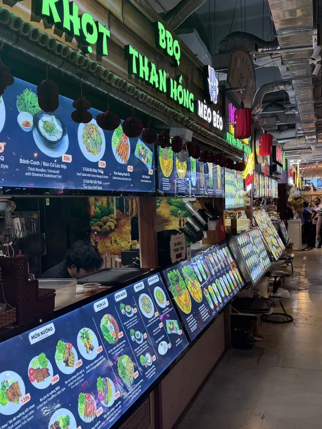 Wide air‑conditioned food court hall inside Central Market Saigon
