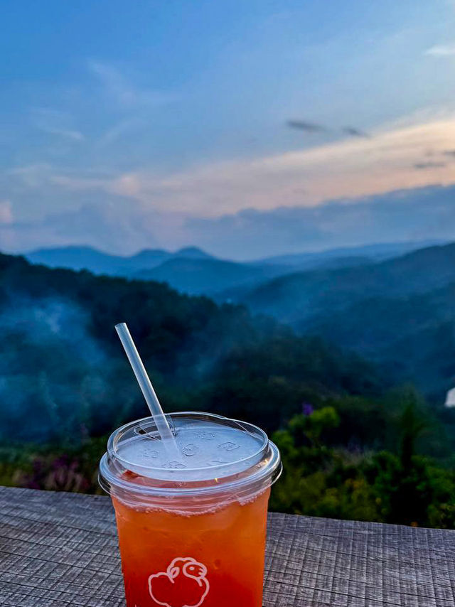 Vietnamese coffee cup on a wooden table overlooking the valley at hidden valley da lat