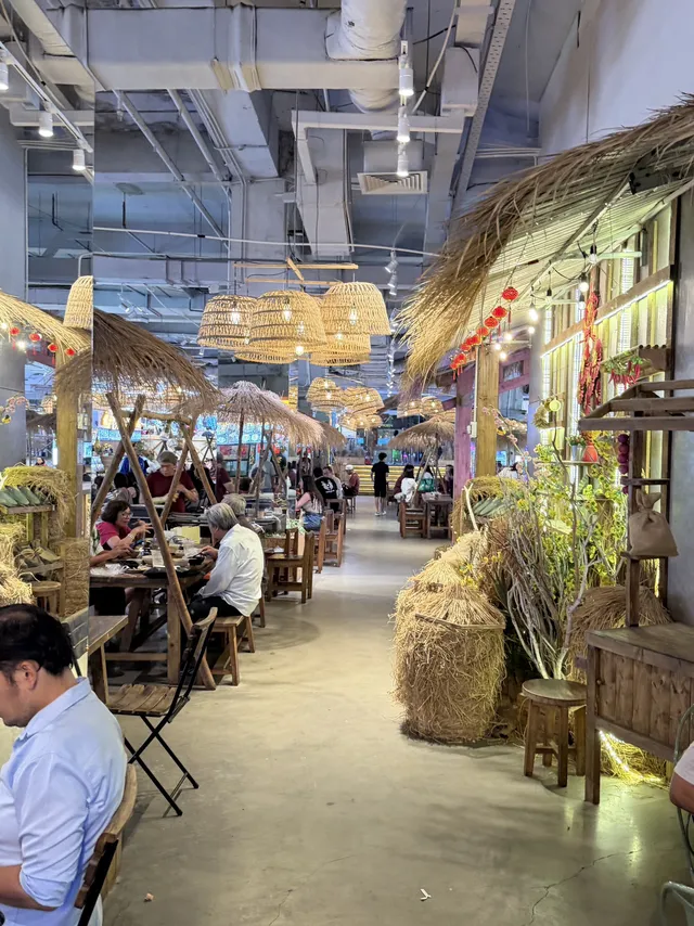 Families and solo travellers eating together in Central Market Saigon seating area