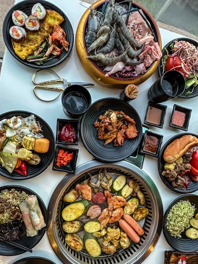 Grilled meats and seafood on a tabletop BBQ at Đà Lạt Buffet BBQ Nha Trang