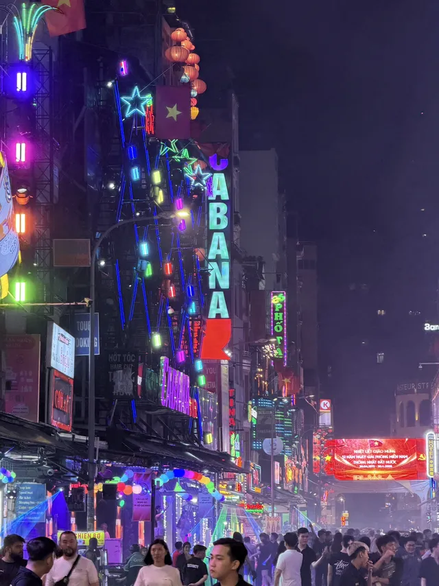 Neon lights and street performers on Bui Vien Walking Street