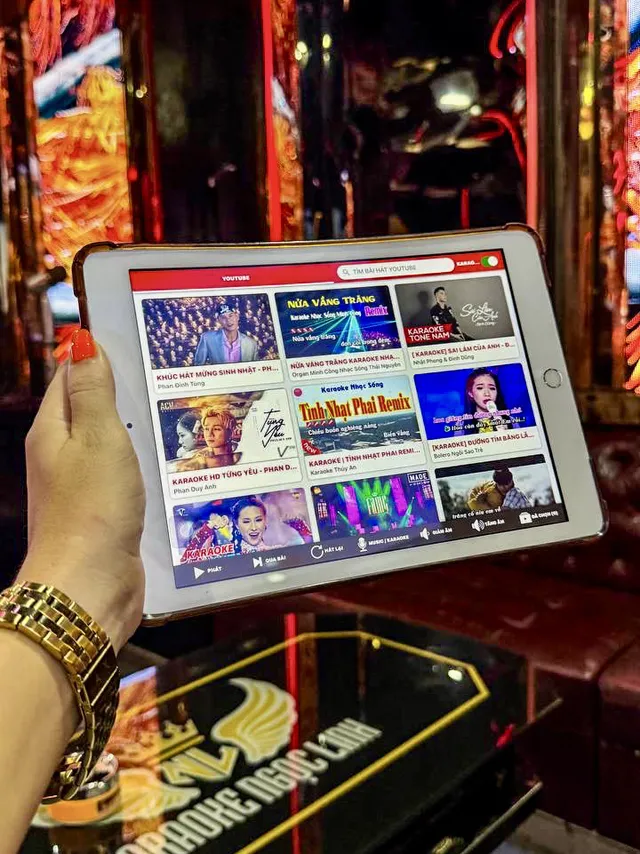 Karaoke song selection tablet in hand at Karaoke Ngoc Linh Nha Trang