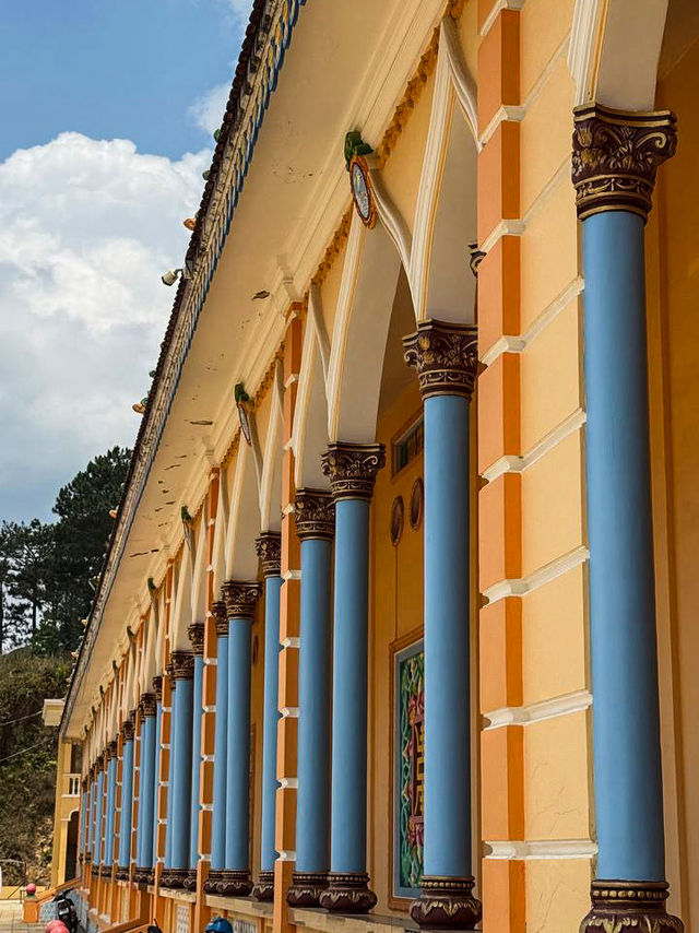 Dragon pillars wrapped around the entrance of Cao Dai Temple Da Lat