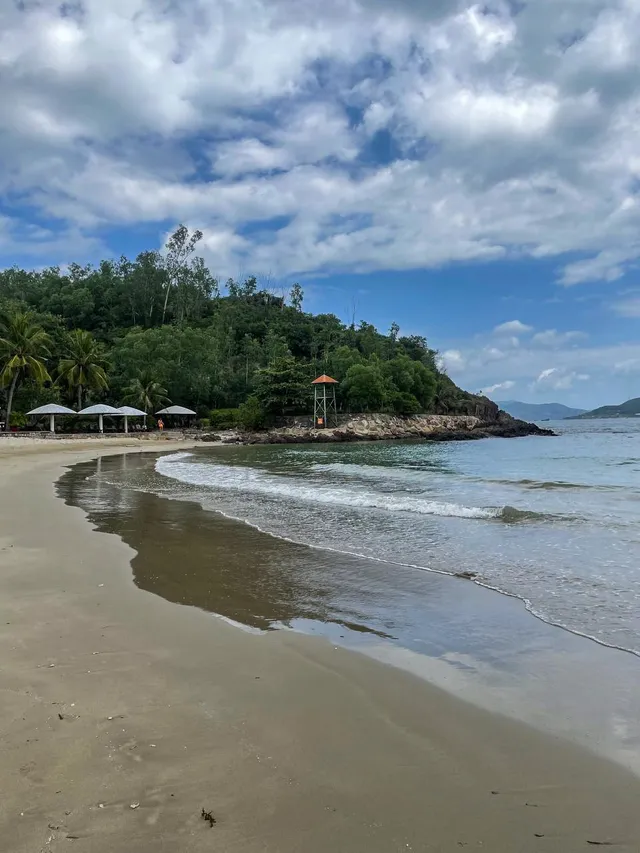 Empty sandy shore with sunbeds at Nhũ Tiên Beach Nha Trang