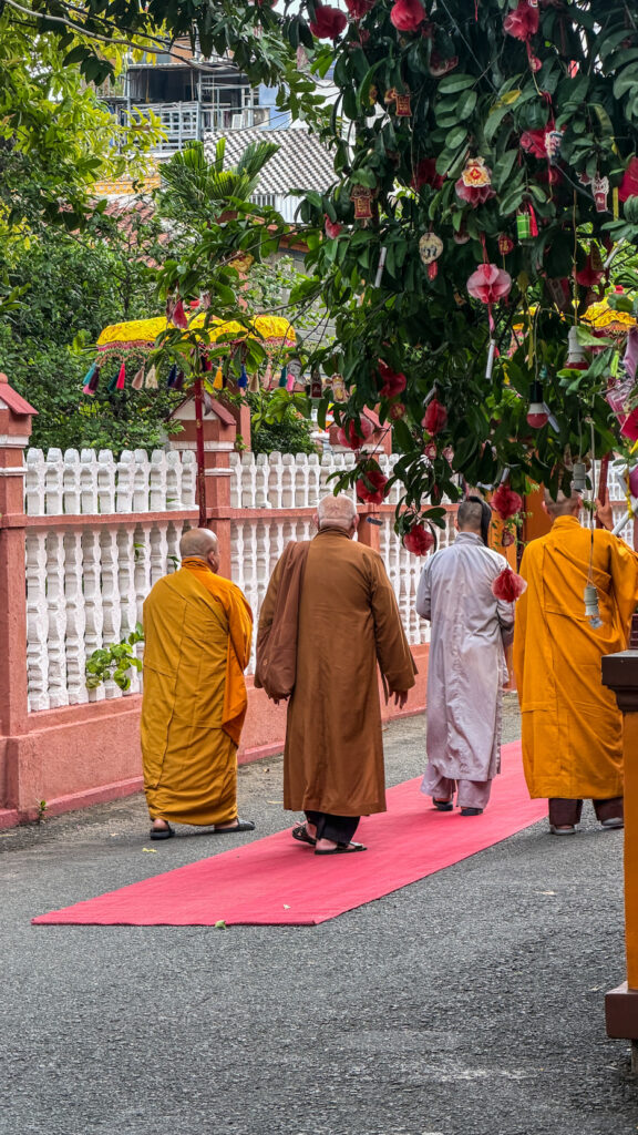 Giac Lam Pagoda Saigon white stupas and golden Buddha statue in garden
