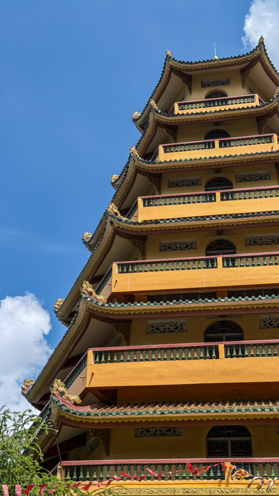 Giac Lam Pagoda Saigon white stupas and golden Buddha statue in garden
