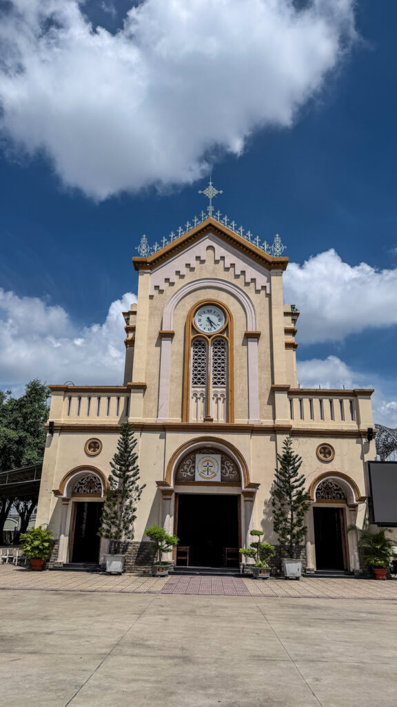 Chi Hoa Church Gothic rose window and stone tower Saigon