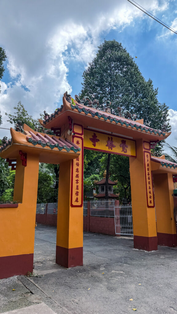 Giac Lam Pagoda Saigon white stupas and golden Buddha statue in garden