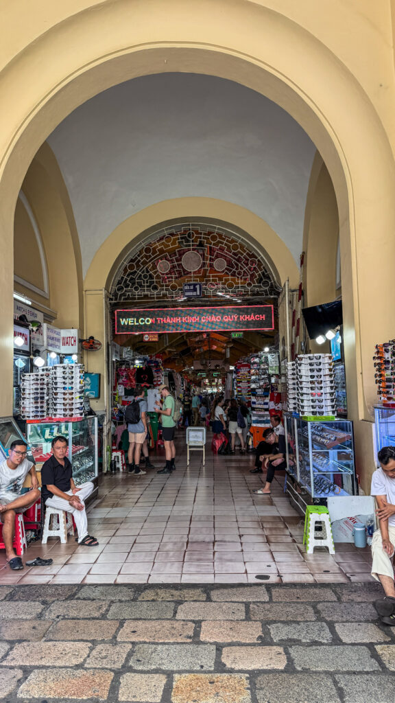 Ben Thanh Market interior with dried fruit stalls and clock tower Saigon