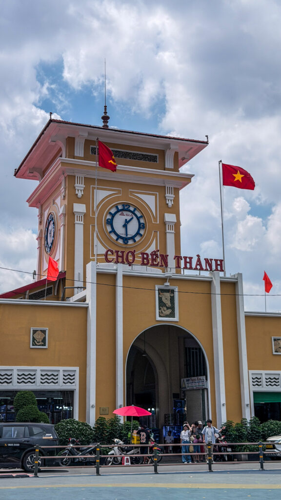 Ben Thanh Market interior with dried fruit stalls and clock tower Saigon