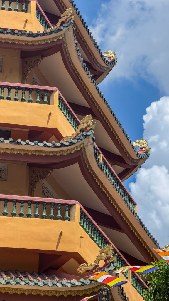 Giac Lam Pagoda Saigon white stupas and golden Buddha statue in garden