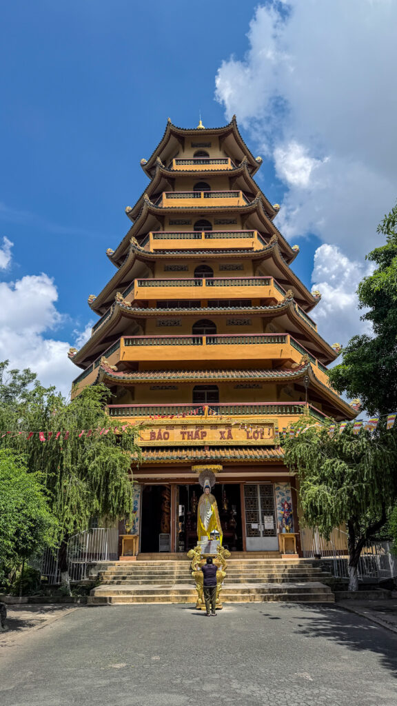 Giac Lam Pagoda Saigon white stupas and golden Buddha statue in garden