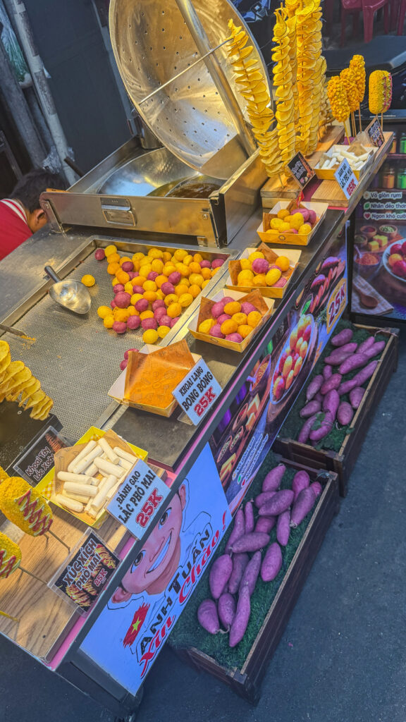 Hồ Thị Kỷ street food alley with grilled chicken and vendors beside the flower market Saigon