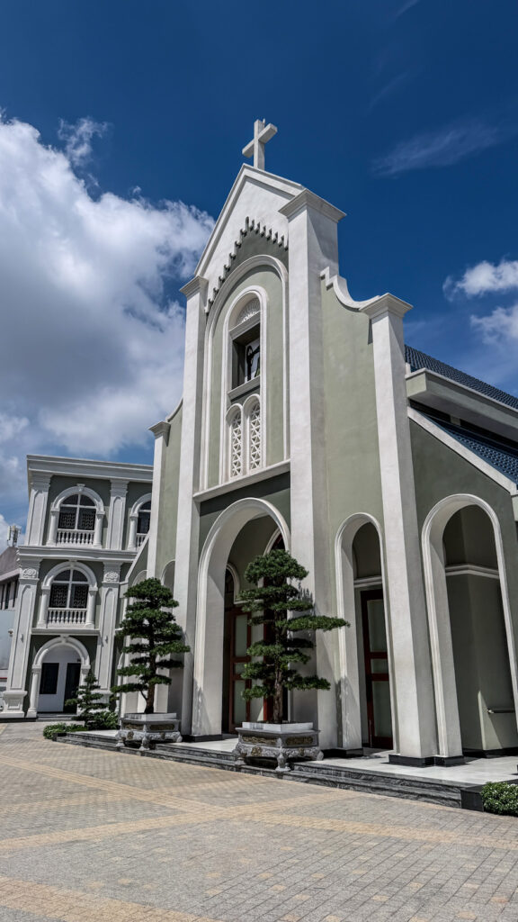 Chi Hoa Church Gothic rose window and stone tower Saigon