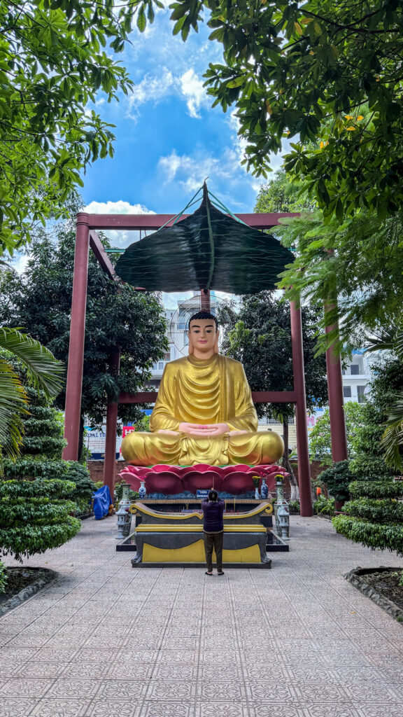 Giac Lam Pagoda Saigon white stupas and golden Buddha statue in garden