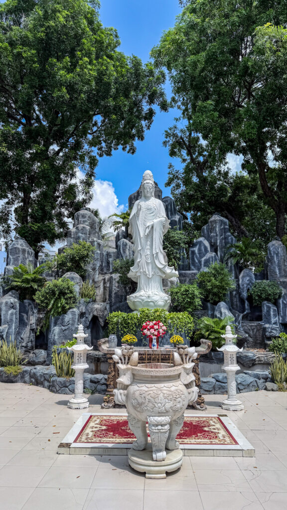 Giac Lam Pagoda Saigon white stupas and golden Buddha statue in garden