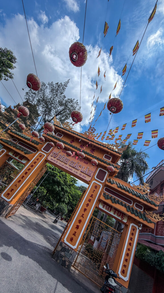 Giac Lam Pagoda Saigon white stupas and golden Buddha statue in garden