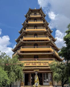 Giac Lam Pagoda Saigon white stupas and golden Buddha statue in garden