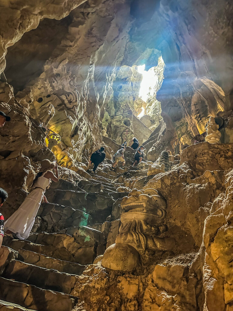 Van Thong Cave rocky passage and Buddha statue in Marble Mountains


