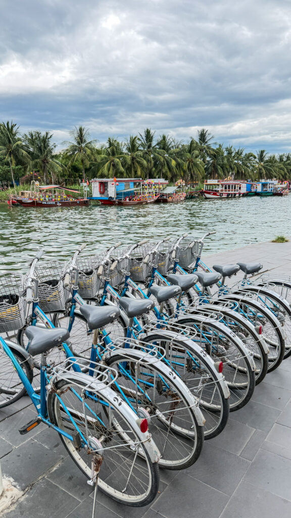 Walking street in Hoi An Old Town with pedestrians and historic architecture

