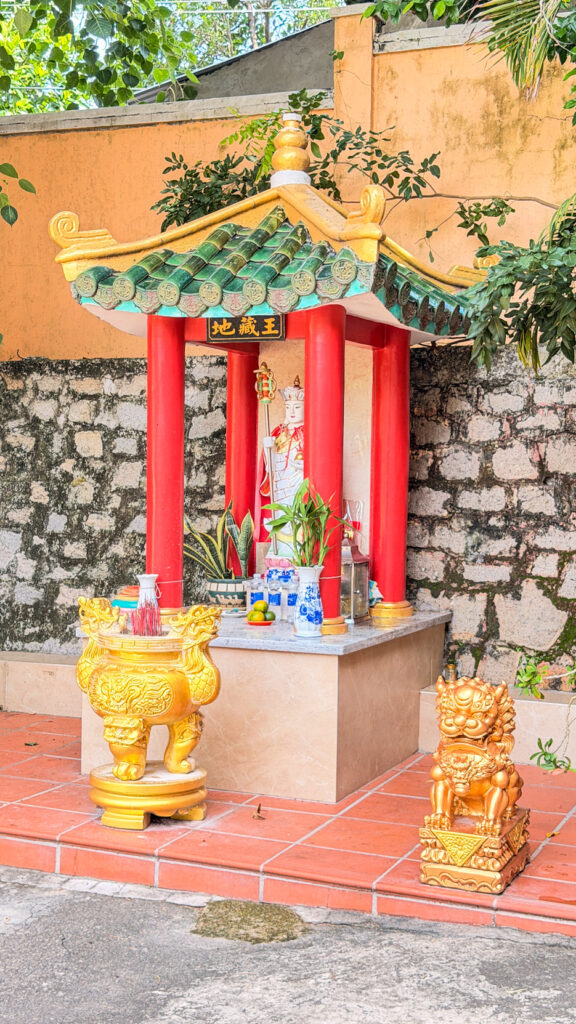 Peaceful temple surrounded by trees and tropical vegetation
