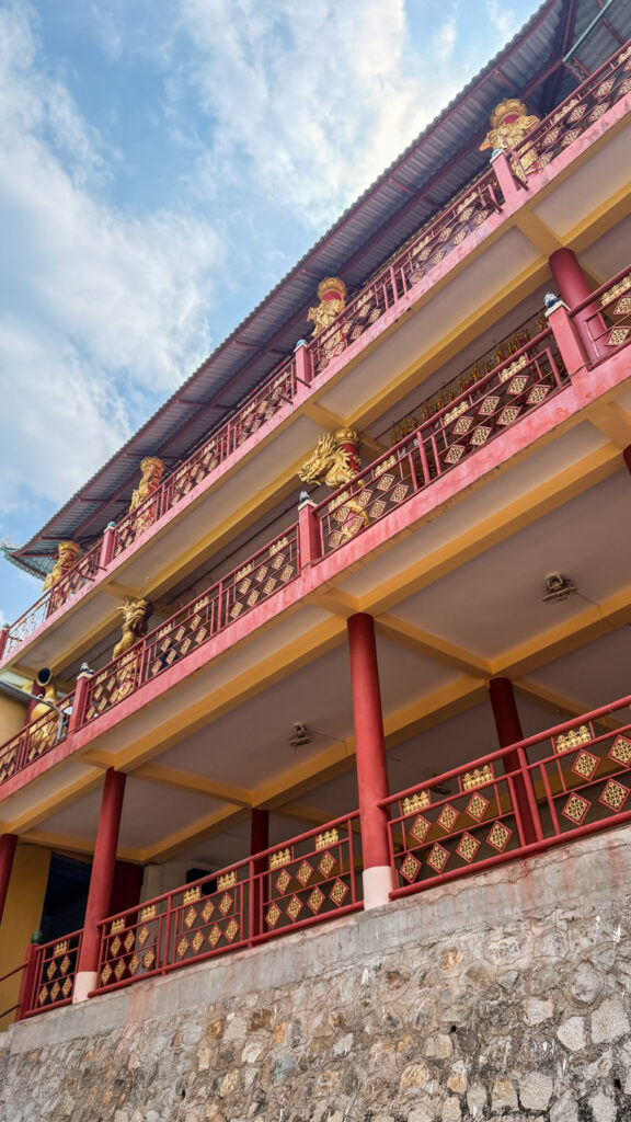 Vietnamese temple with ornate entrance and religious decorations
