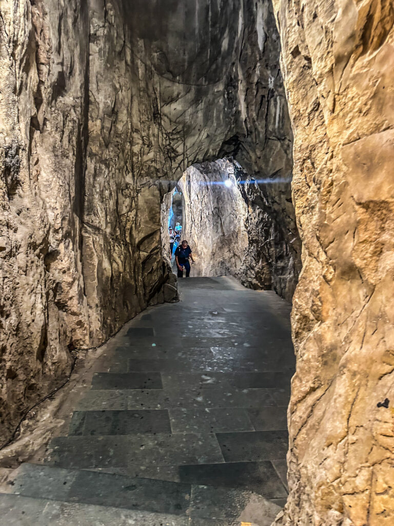 Van Thong Cave rocky passage and Buddha statue in Marble Mountains

