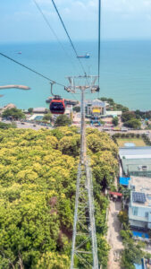 Hồ Mây cable car rising above Vung Tau with the city and sea below