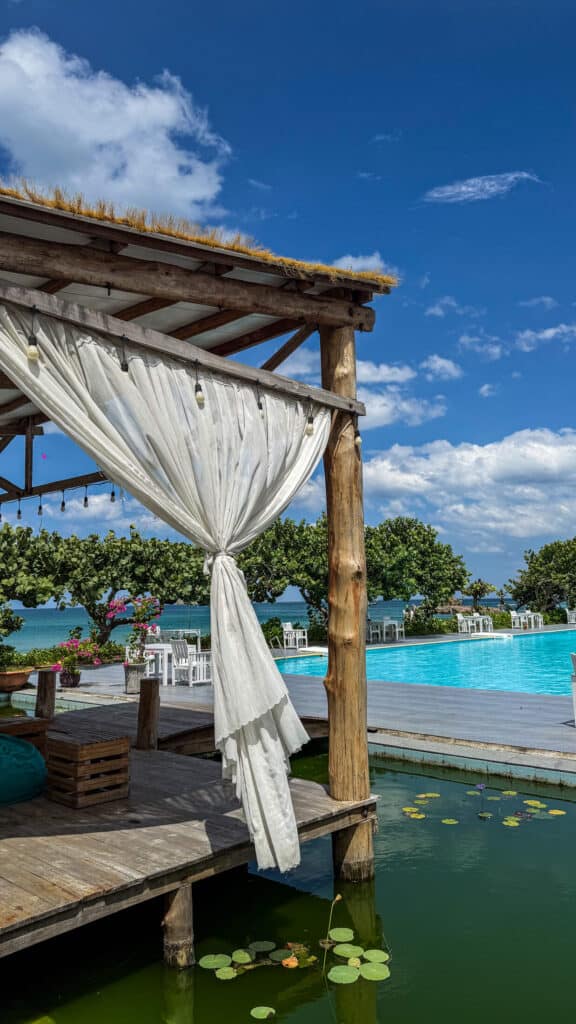 Thatched-roof cabana beside the pool and lily pond at Ana Resort Phu Yen