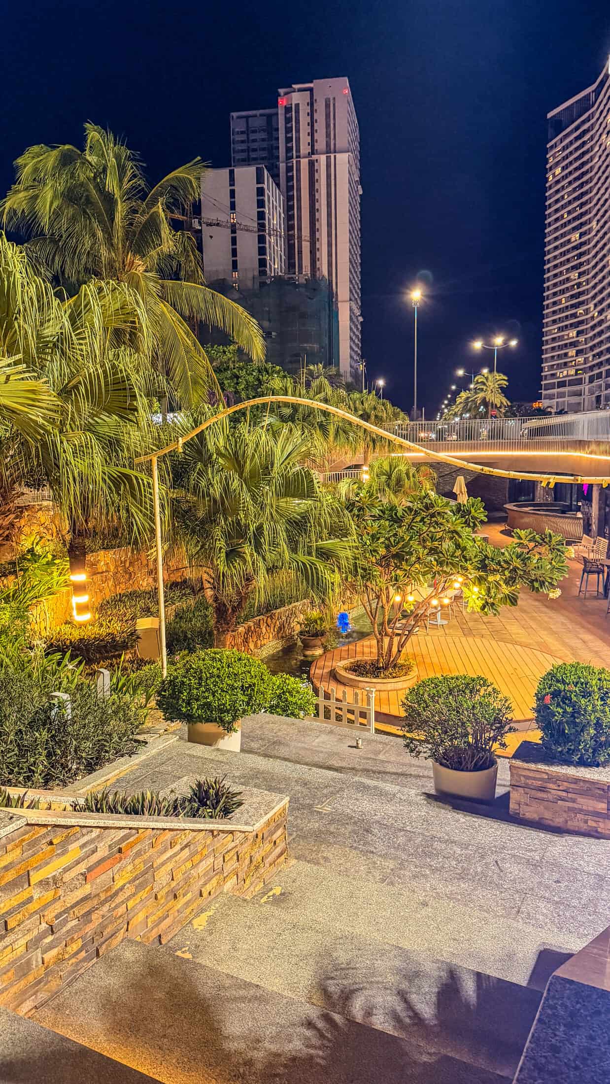 Night terrace with palm lighting at Aqua Beach Club, Quy Nhon