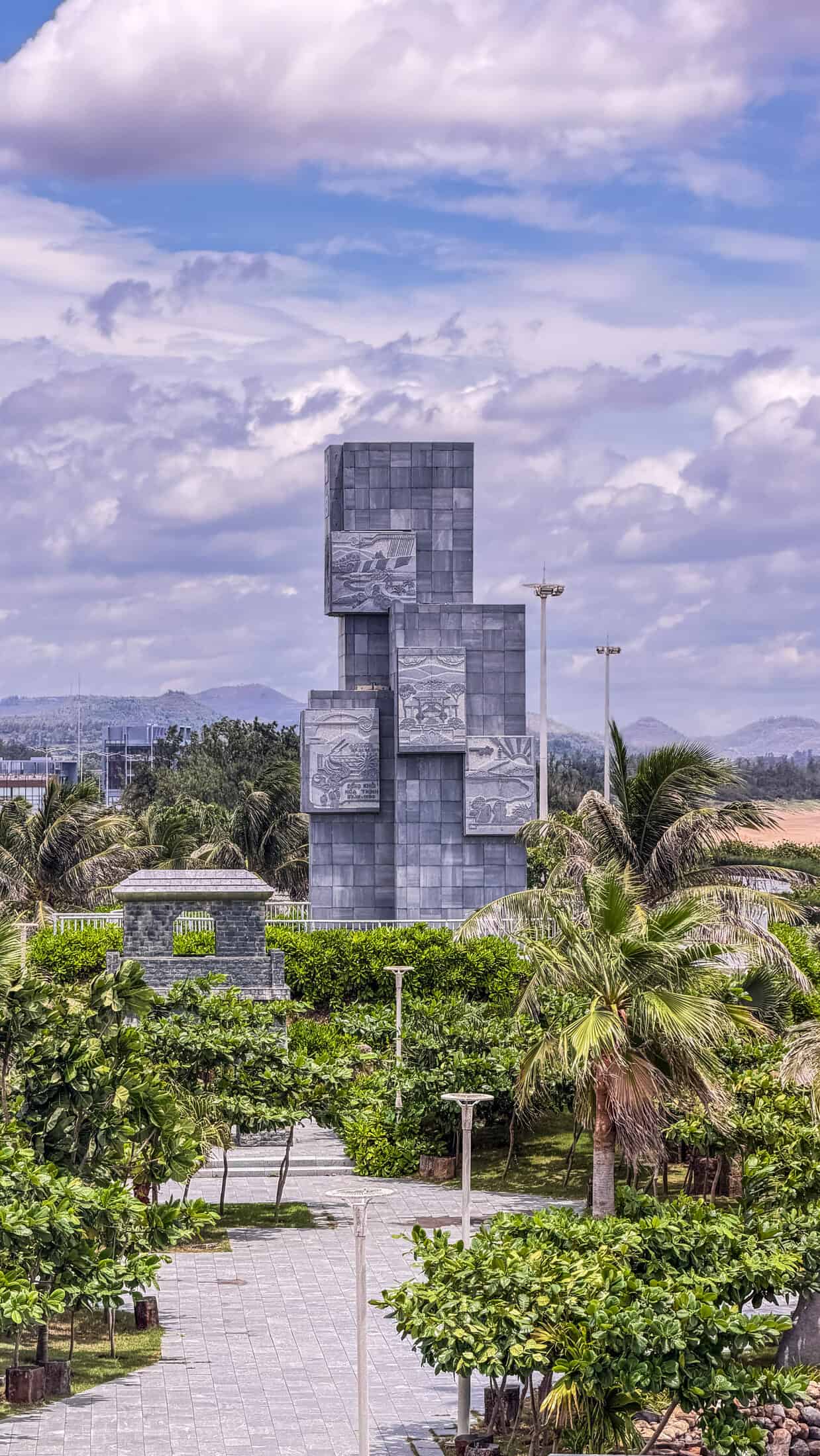 Carved granite relief panels at the base of Nghinh Phong Tower depicting Phu Yen legends