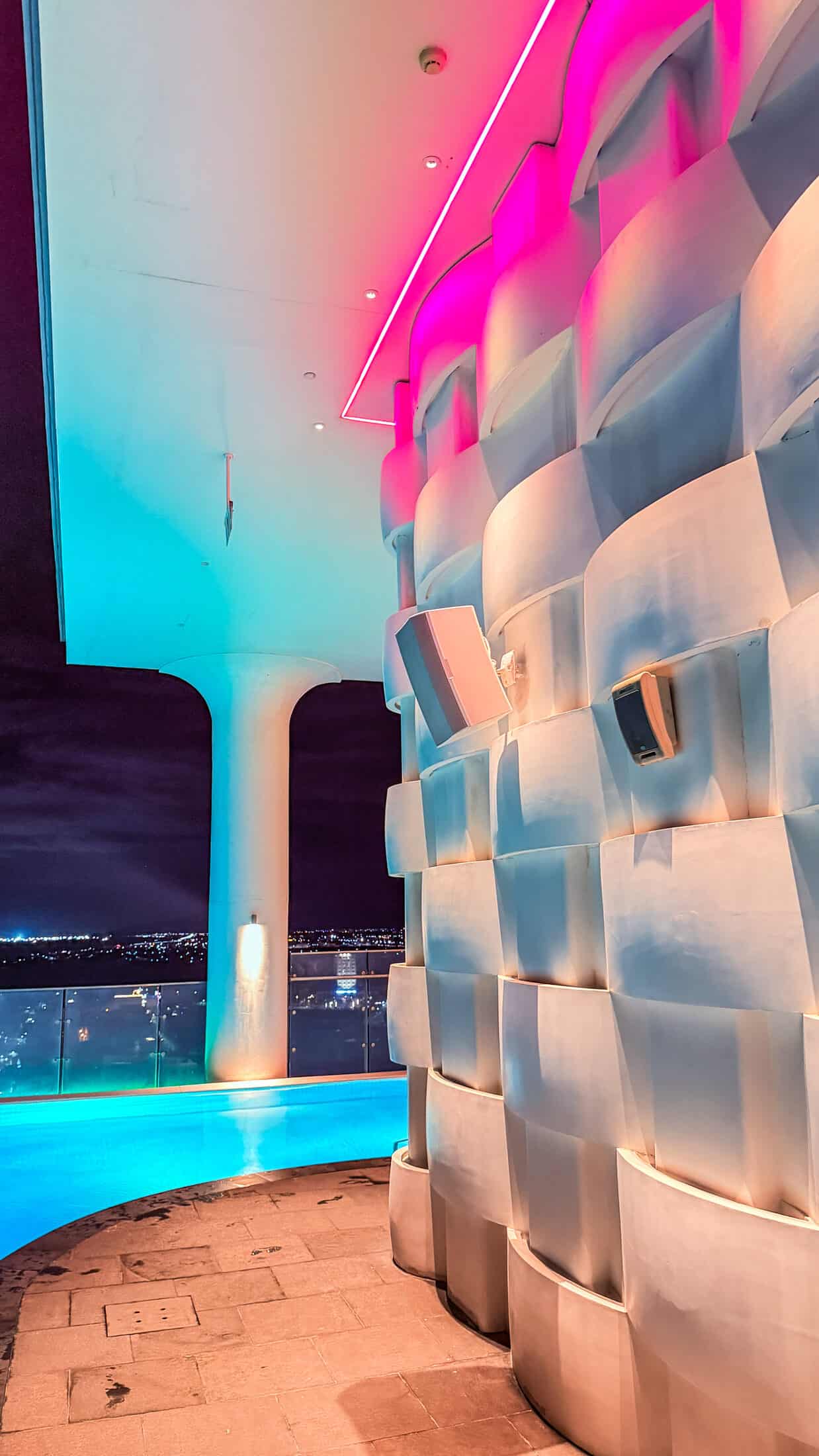 Glowing infinity pool overlooking the city at night at Endless Summer Rooftop Pool and Bar, Tuy Hoa
