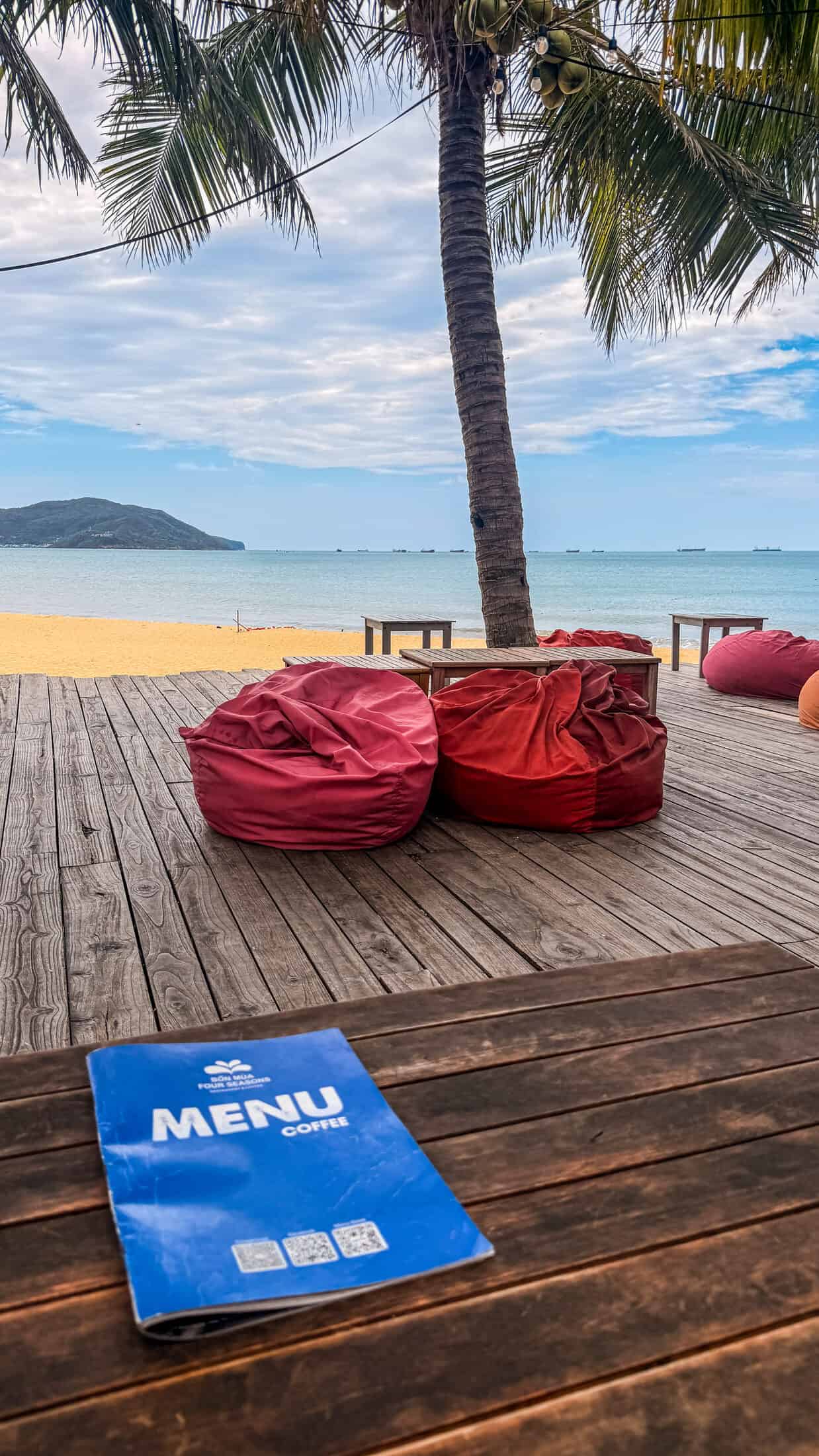 Coffee menu on the table with beach view at Bốn Mùa (Four Seasons), Quy Nhon