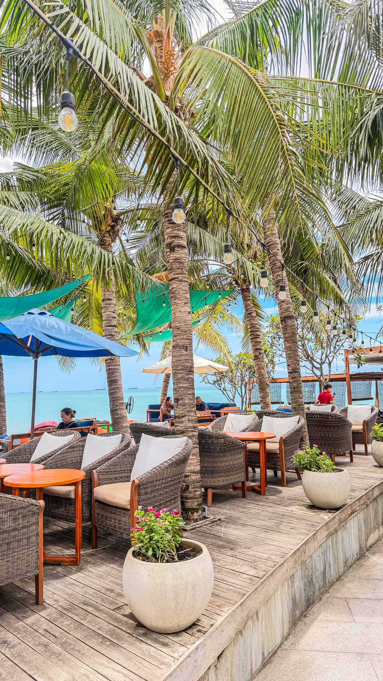 Rattan chairs and string lights under the palms at Bốn Mùa (Four Seasons), Quy Nhon