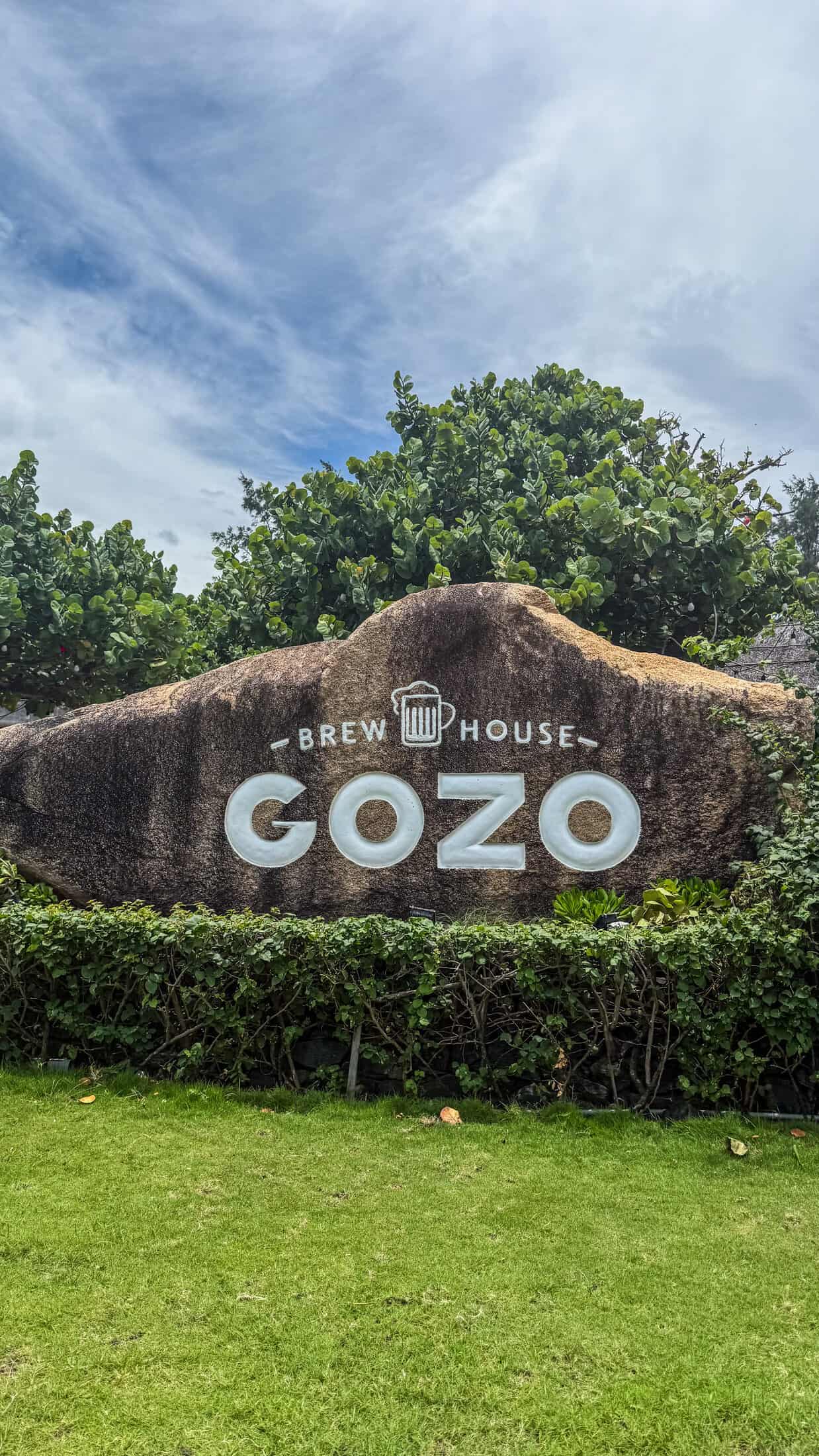 Gozo Brew House sign carved into a stone boulder at the entrance, Tuy Hoa