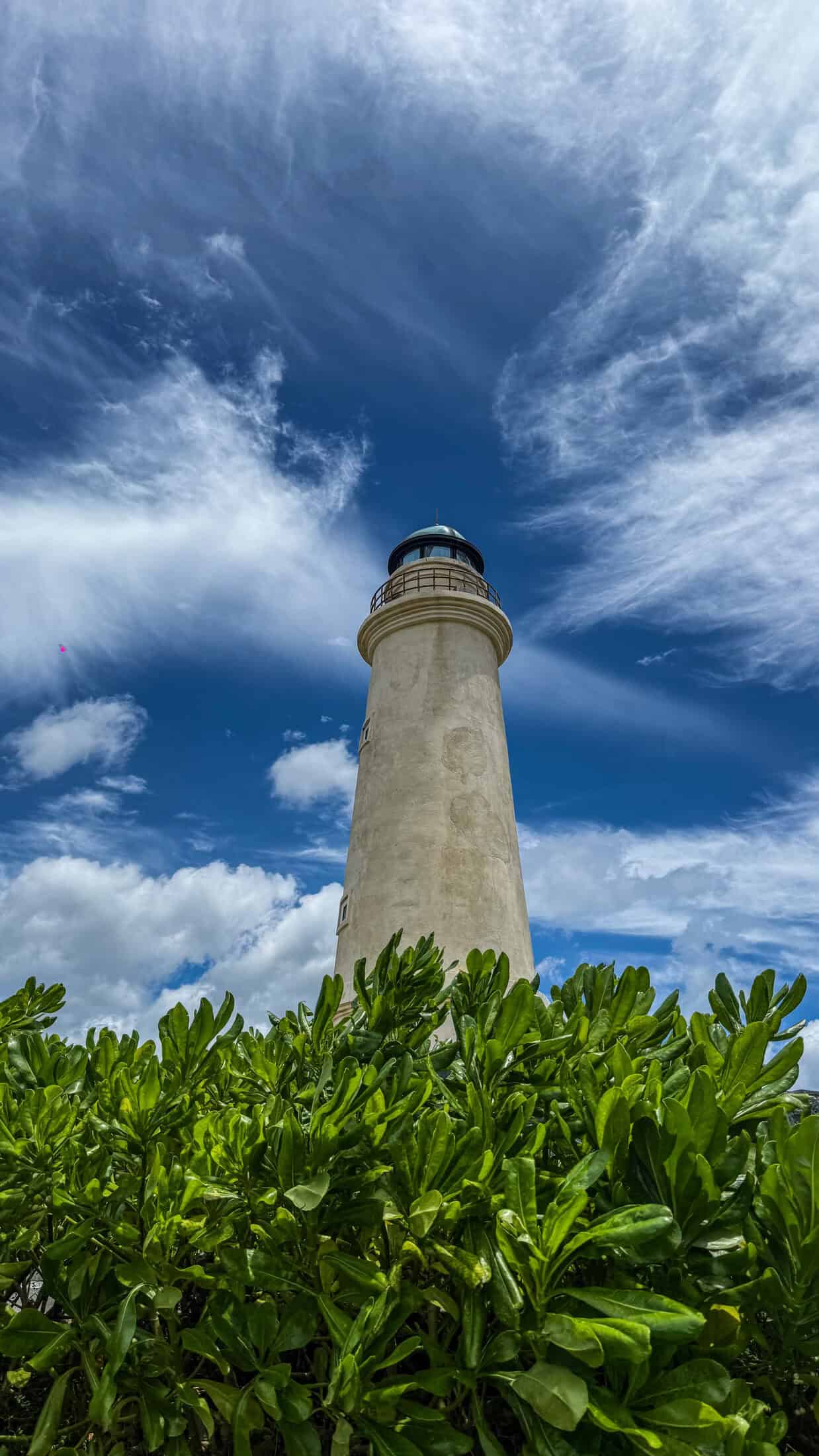 Close-up view of the miniature lighthouse tower against a blue sky in Tuy Hoa