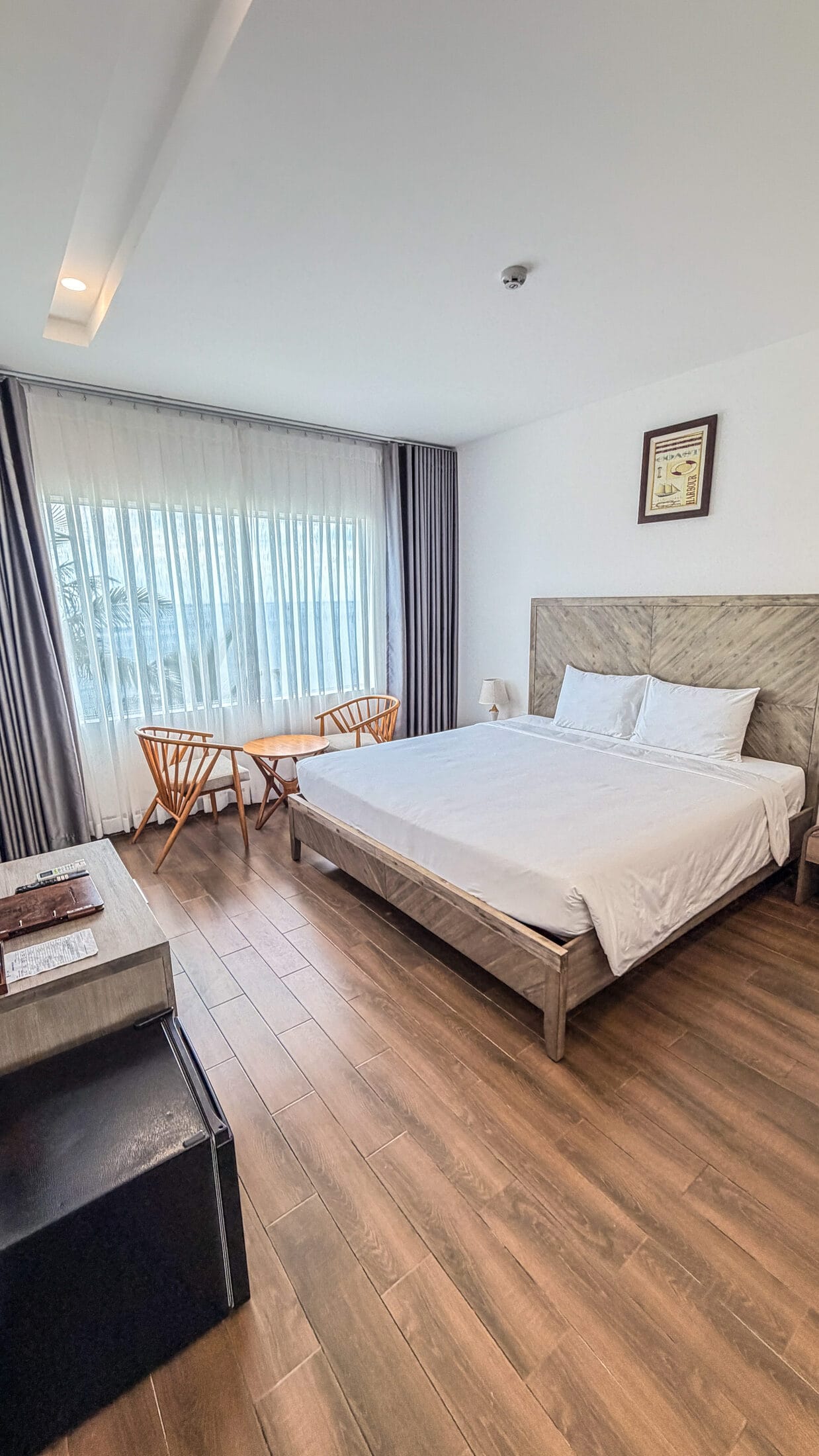 Sea-view bedroom with wood headboard at La Costa Resort, Quy Nhon