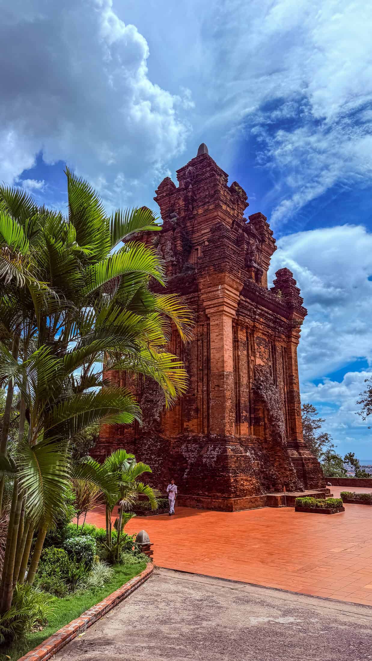 Ancient brick Cham tower of Nhan Tower rising above palm trees in Tuy Hoa