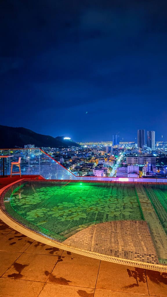 Rooftop pool overlooking the city at night at Ruby Sky Bar & Restaurant, Quy Nhon