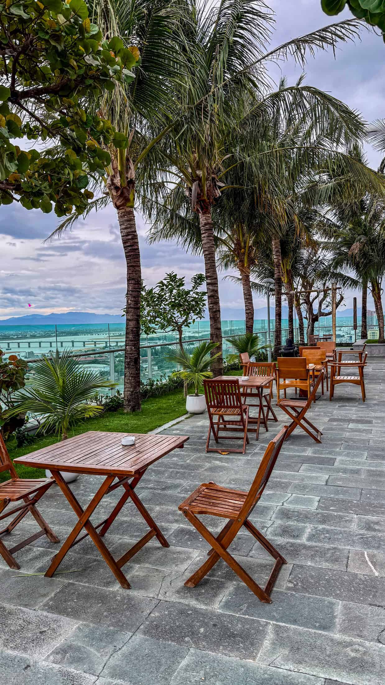Rooftop terrace with palm trees at Sala Grand Tuy Hoa Hotel